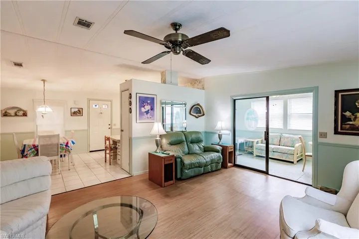 Living room featuring light hardwood / wood-style flooring and ceiling fan