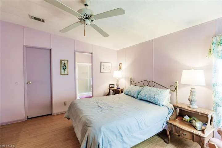 Bedroom with ceiling fan and light wood-type flooring