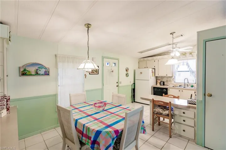 Tiled dining area with ceiling fan and sink