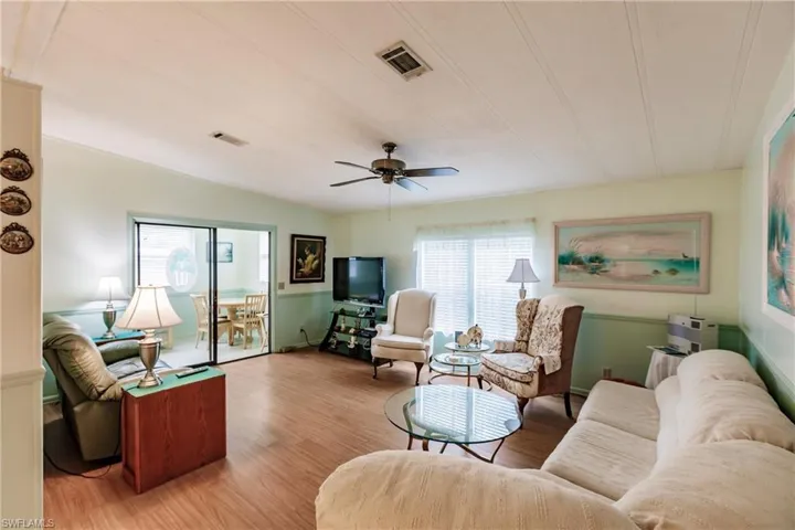 Living room featuring light hardwood / wood-style floors, a wealth of natural light, and ceiling fan