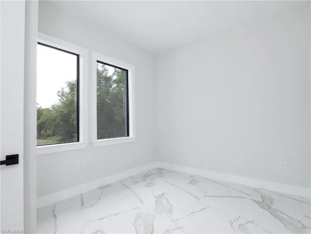Spare room featuring a wealth of natural light