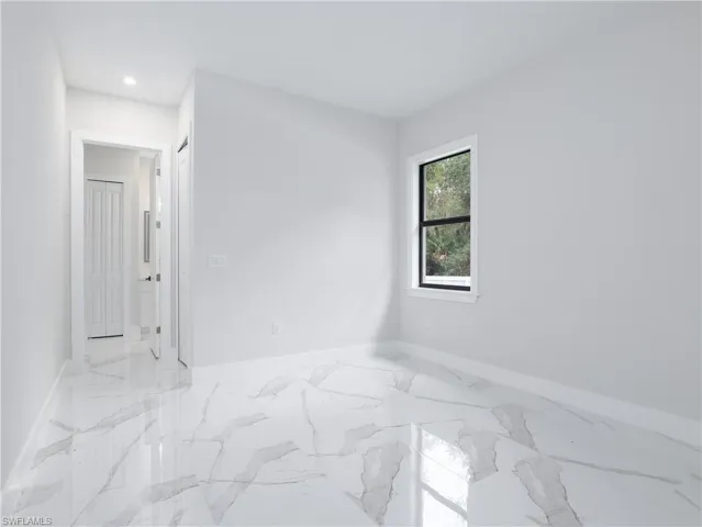 Unfurnished room featuring light tile patterned floors