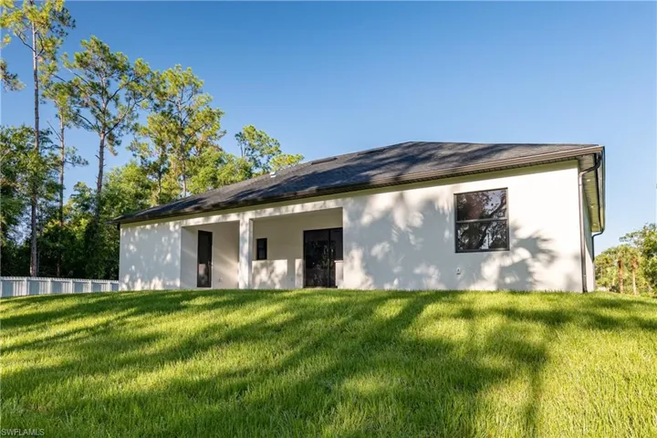 Back of property with a yard
