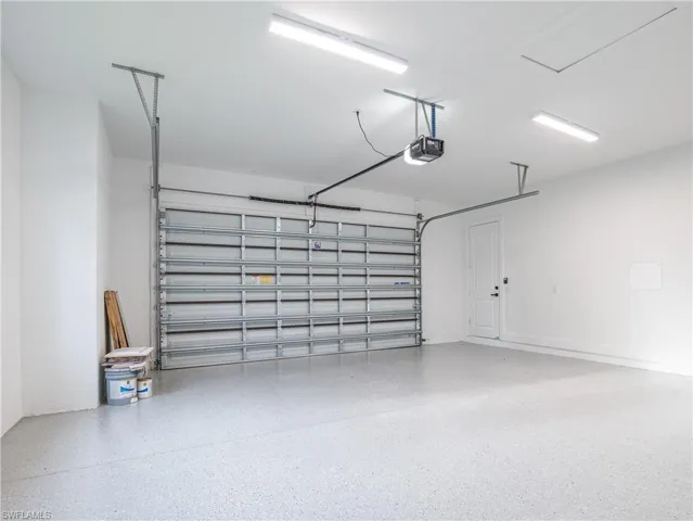 Garage featuring a garage door opener