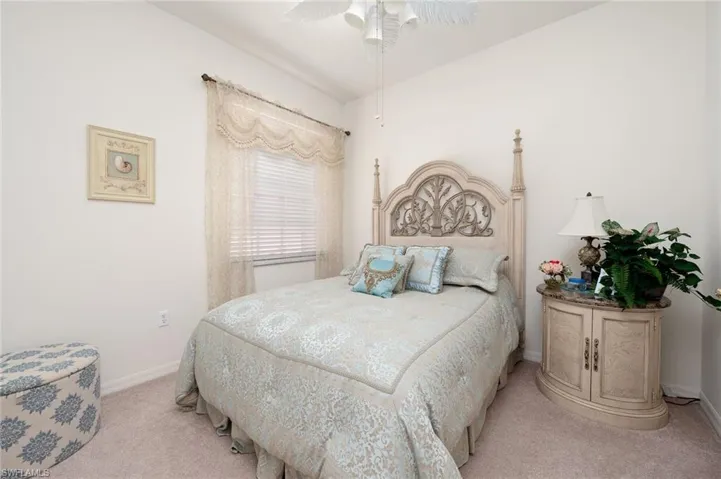 Carpeted bedroom with ceiling fan