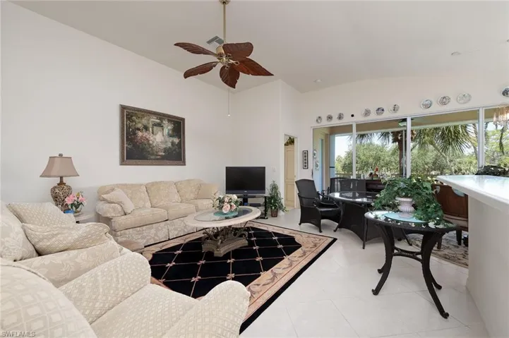 Tiled living room featuring ceiling fan