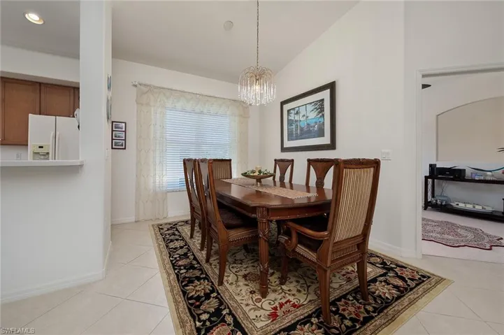 Dining area featuring a chandelier and light tile floors