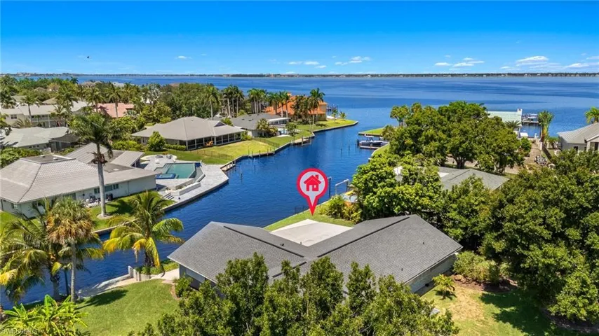 Birds eye view of property with a water view