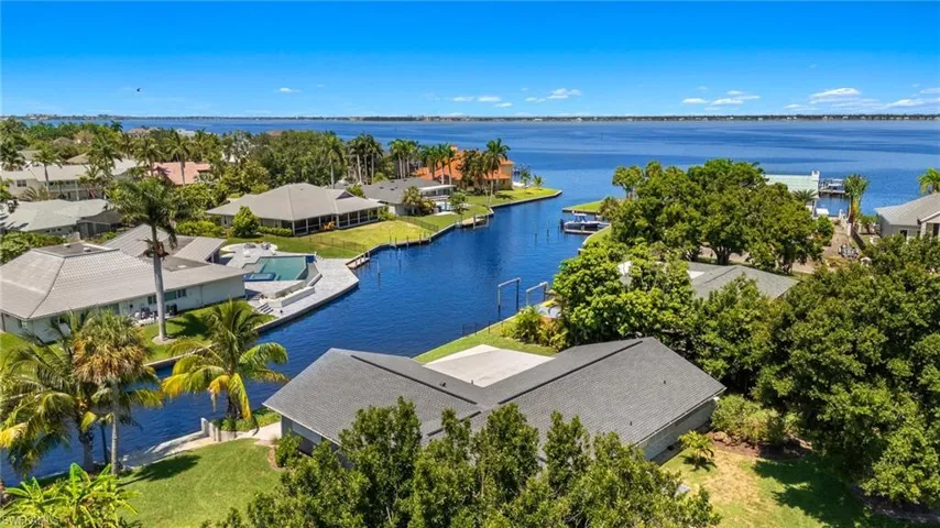 Birds eye view of property with a water view
