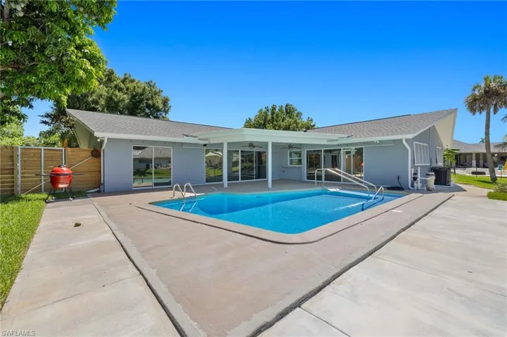 View of swimming pool and rear of home