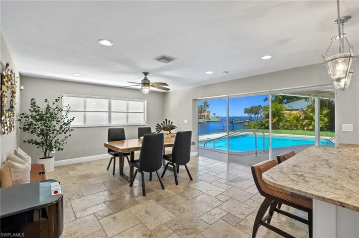 Dining space featuring light tile flooring and ceiling fan