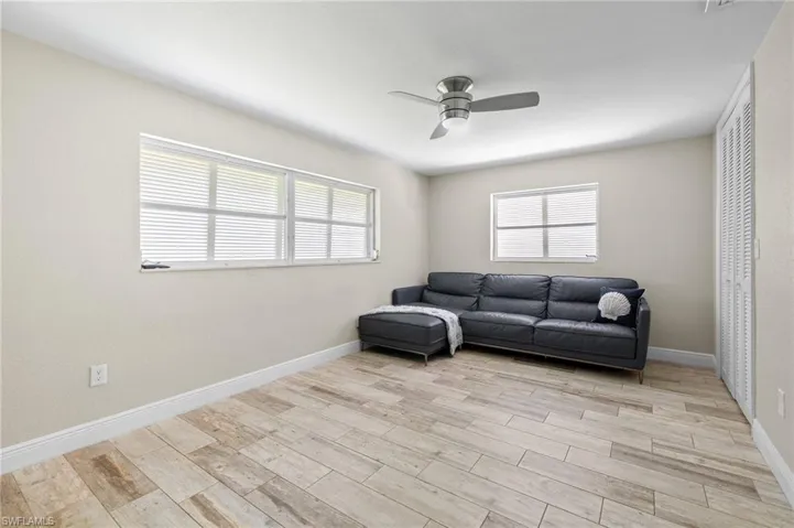Sitting room featuring plenty of natural light, ceiling fan, and light hardwood / wood-style floors