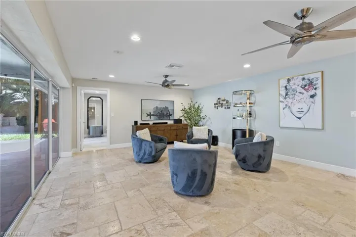 Living room featuring ceiling fan and light tile floors