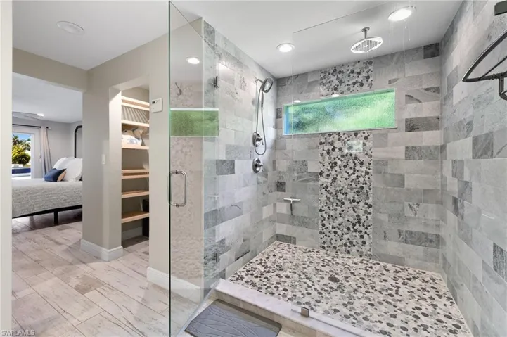 Bathroom featuring walk in shower and hardwood / wood-style flooring
