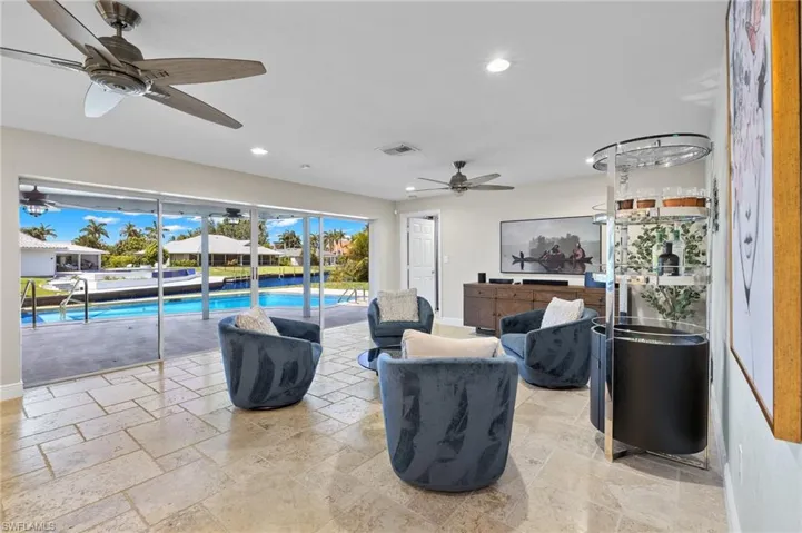 Tiled living room featuring ceiling fan