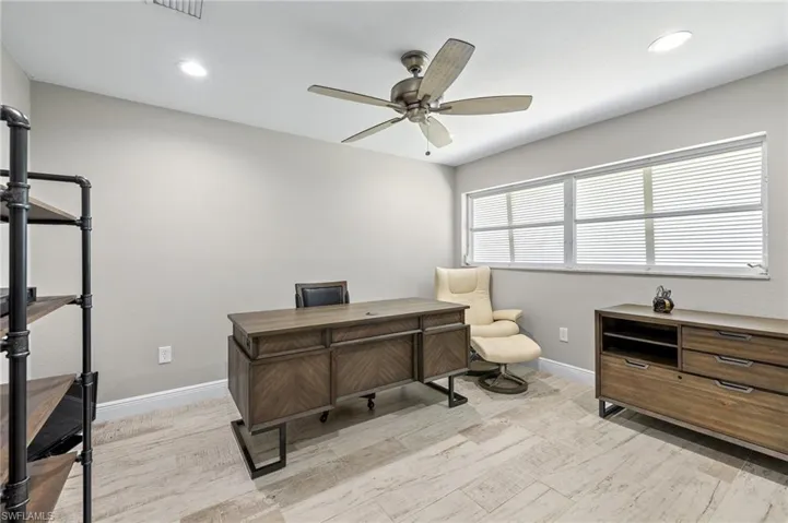 Office space featuring light wood-type flooring and ceiling fan