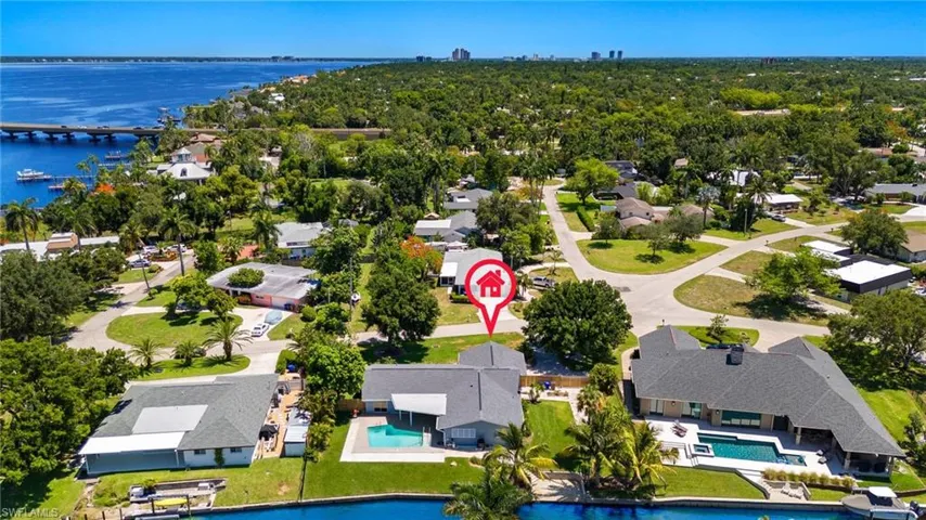 Birds eye view of property with a water view