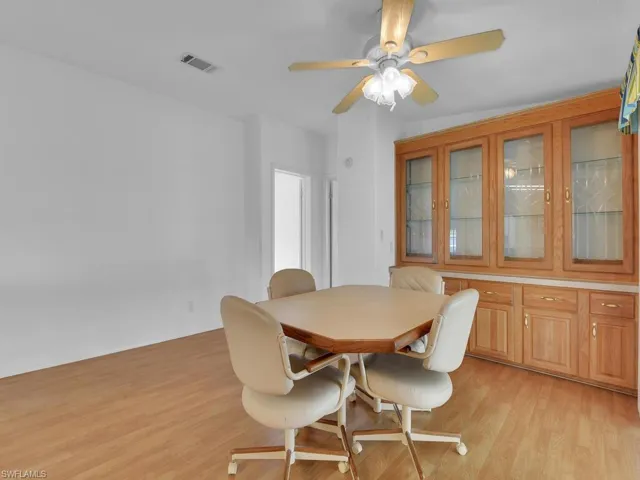 Dining area with ceiling fan and light hardwood / wood-style floors