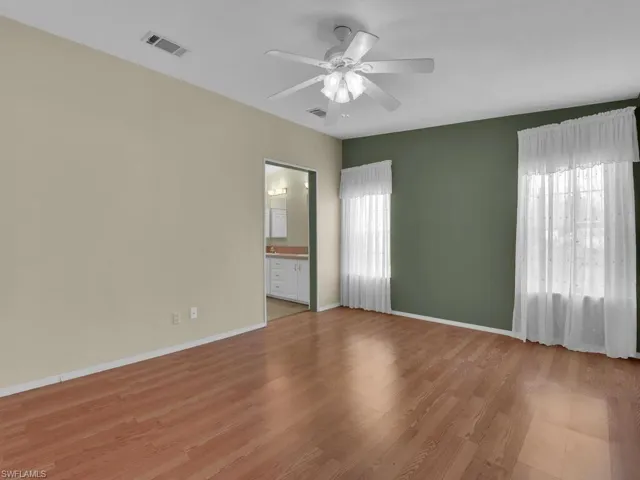 Spare room featuring ceiling fan and light wood-type flooring