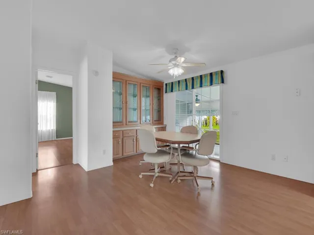 Dining area featuring light hardwood / wood-style floors, vaulted ceiling, and ceiling fan