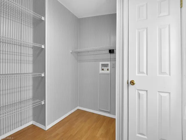 Laundry area with hookup for a washing machine and hardwood / wood-style floors