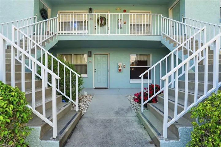 Doorway to property with stucco siding