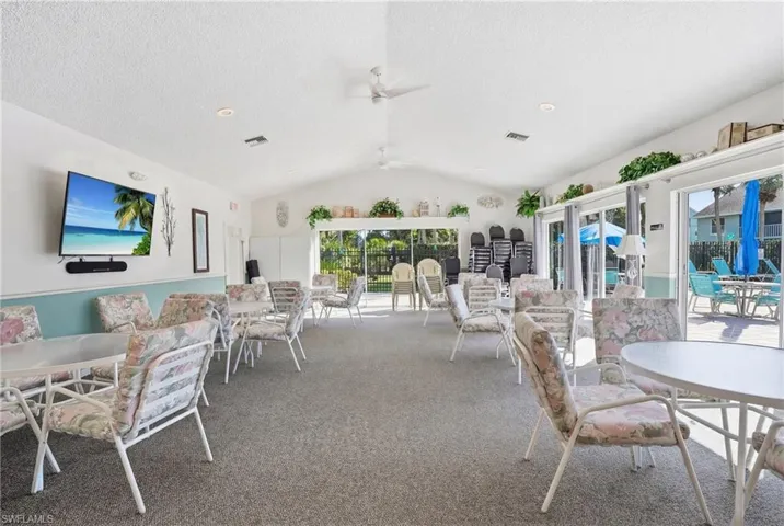 Dining room featuring carpet, ceiling fan, and a textured ceiling