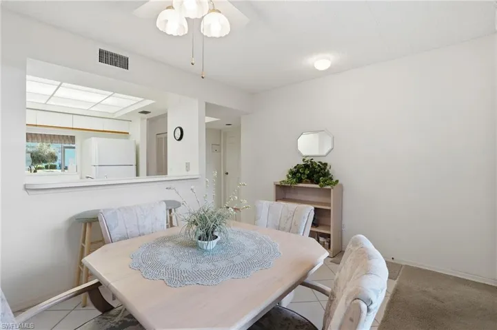 Dining space featuring a ceiling fan and light tile patterned flooring