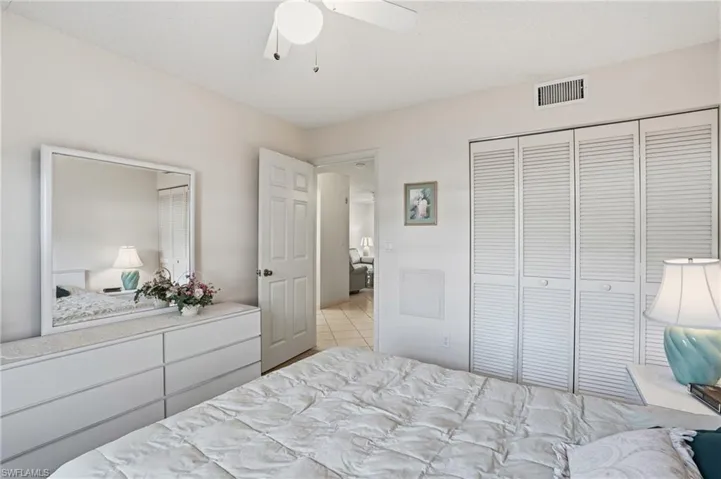 Bedroom with a ceiling fan and a closet