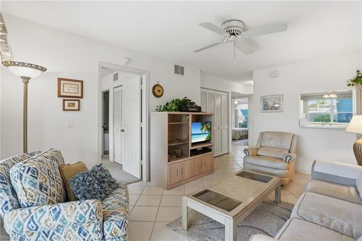 Living room featuring ceiling fan and light tile patterned floors