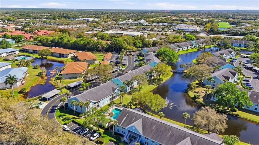 Aerial view of property's location with a nearby body of water and nearby suburban area