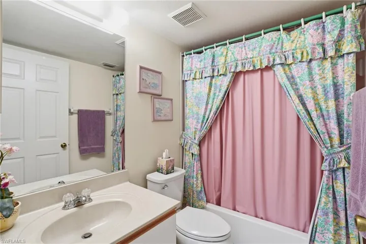 Bathroom with vanity and shower / bathtub combination with curtain