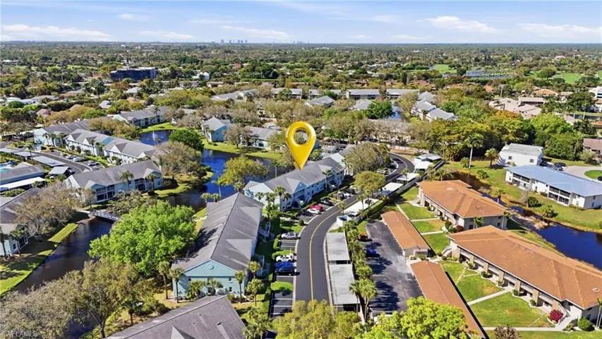 Aerial perspective of suburban area with a nearby body of water