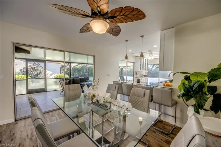Dining space with wood finished floors, a ceiling fan, and recessed lighting