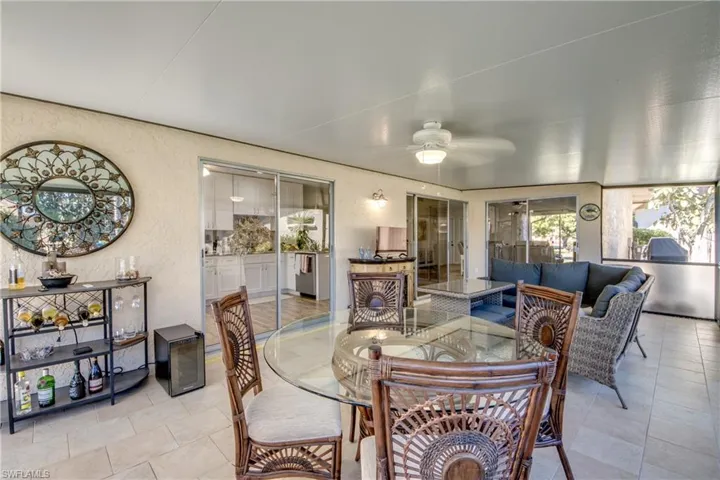 Dining space featuring a textured wall and a ceiling fan
