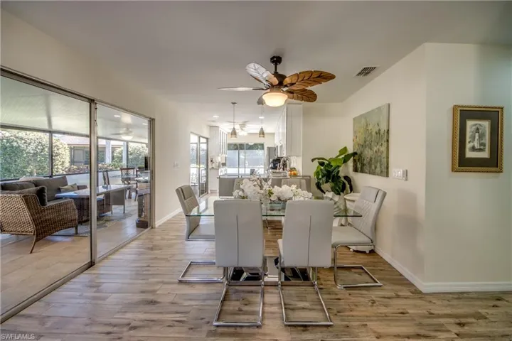 Dining area with light wood-type flooring and a ceiling fan