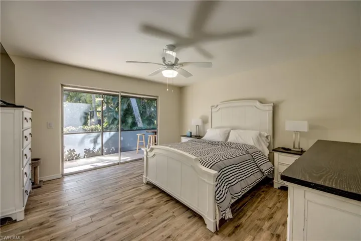Bedroom featuring light wood-style flooring, access to exterior, and ceiling fan