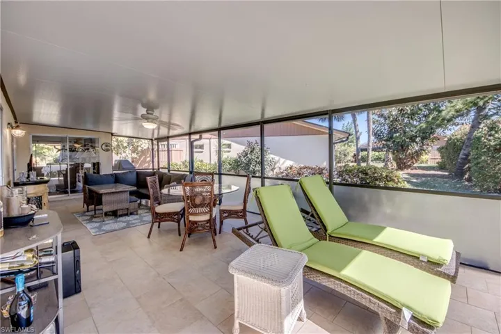 Sunroom with ceiling fan and an outdoor living / dining area