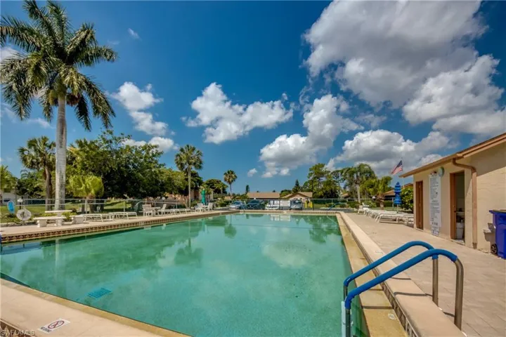 Community pool with a patio