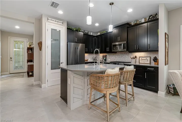 Beautiful kitchen with expresso cabinets and recessed lighting.