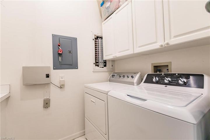 In unit Laundry with cabinets.