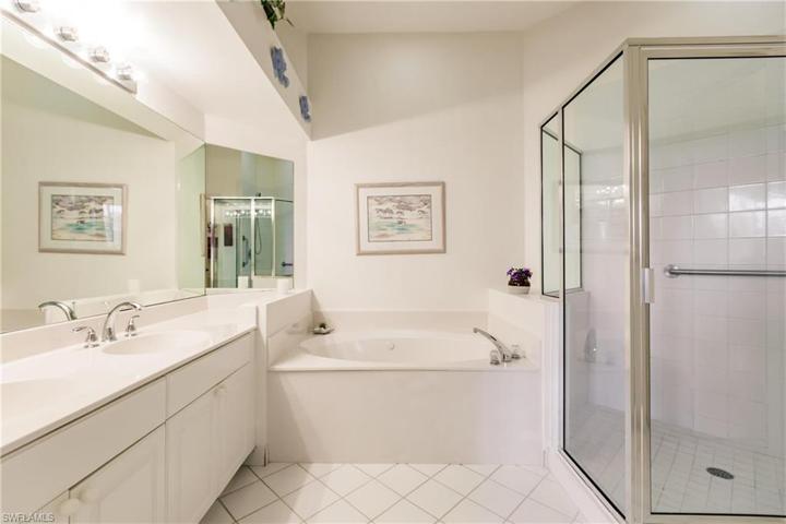 Primary Bathroom with dual sinks, soaking tub, and walk in shower.