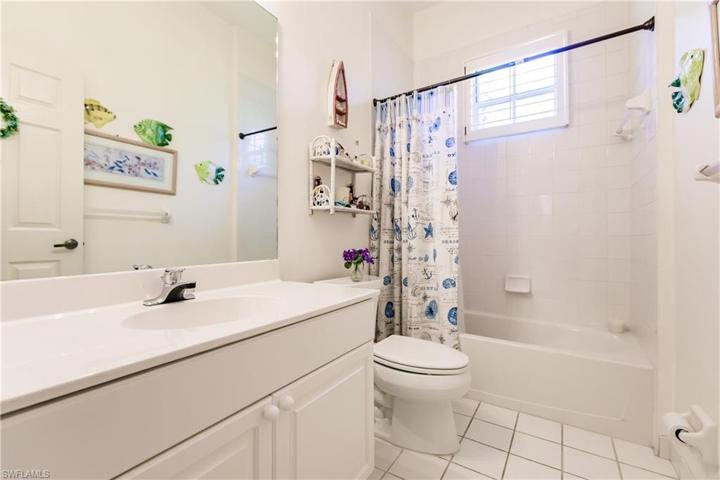 Bath #2 with tub/shower combo. Yes, another window and plantation shutter.