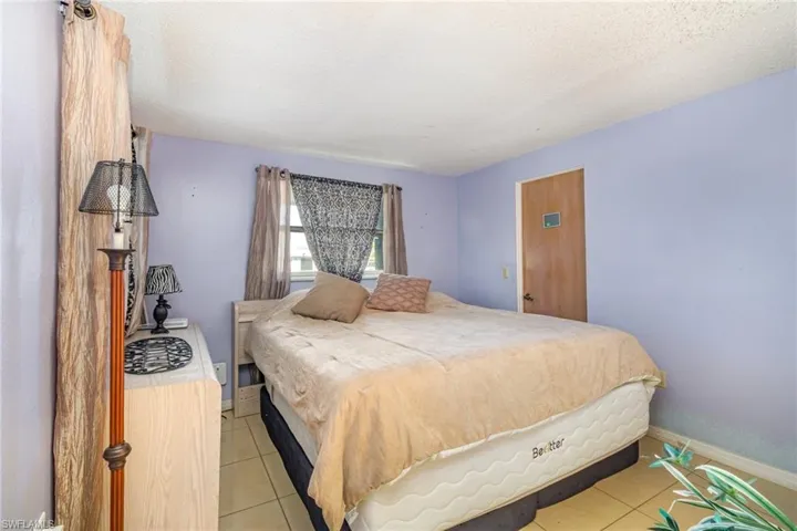 Tiled bedroom featuring a textured ceiling