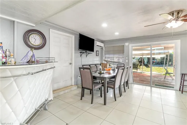 Dining space featuring light tile patterned flooring, ceiling fan, recessed lighting, and ornamental molding