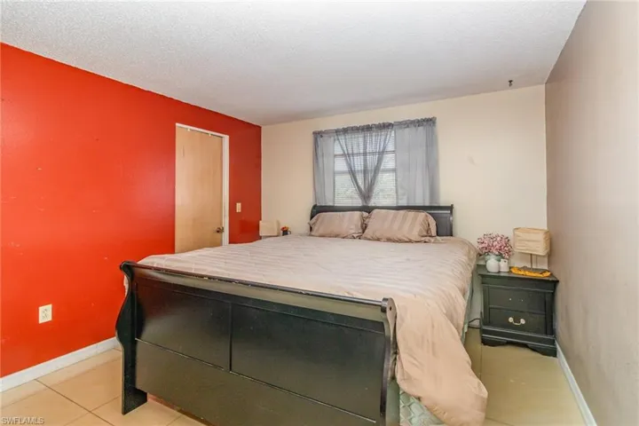 Tiled bedroom featuring a textured ceiling