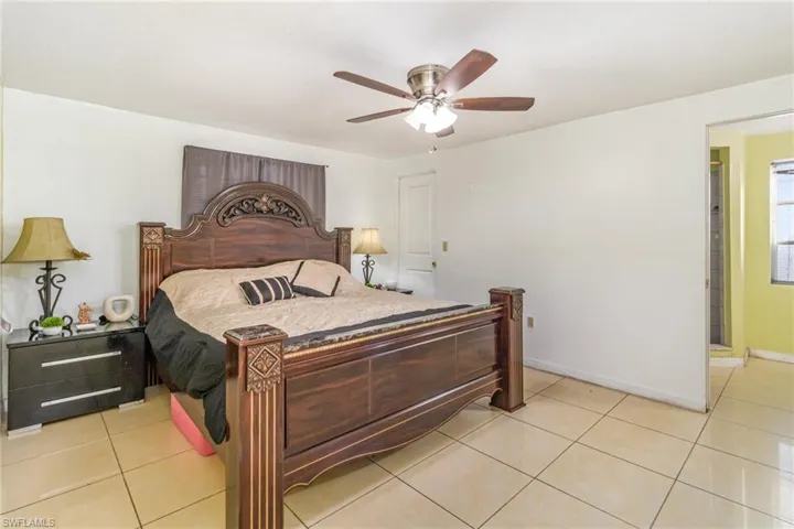 Bedroom featuring light tile patterned flooring and a ceiling fan