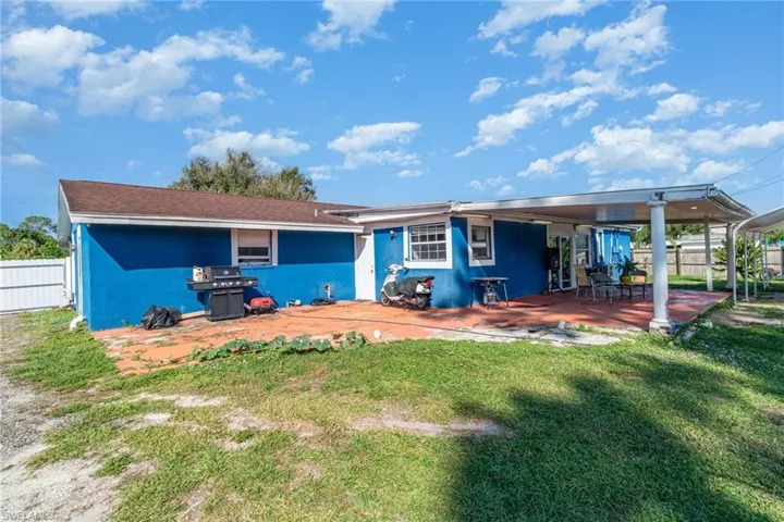 Back of property with a patio and stucco siding