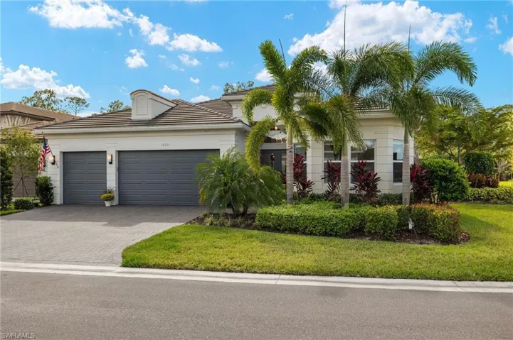 View of front of home with a garage and a front yard