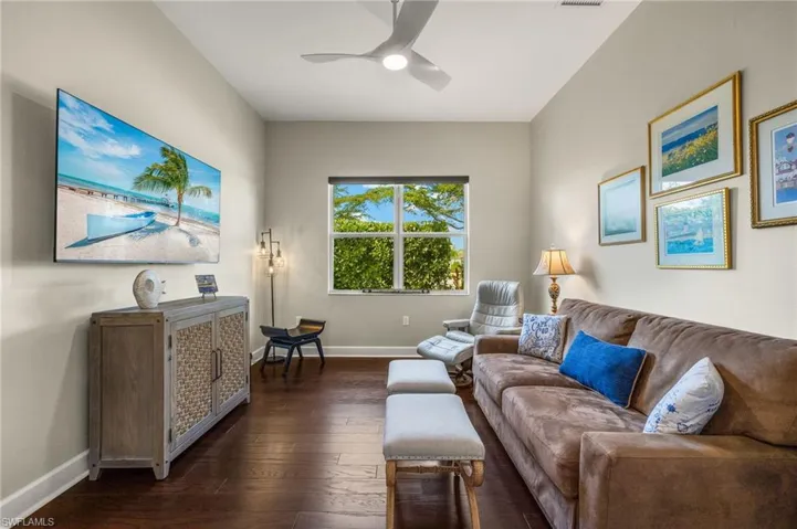 Den featuring dark hardwood / wood-style floors and ceiling fan